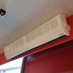 An 860 heater installed above a door at a phone shop
