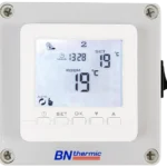 Digital thermostat displaying time, set temperature, and current room temperature.