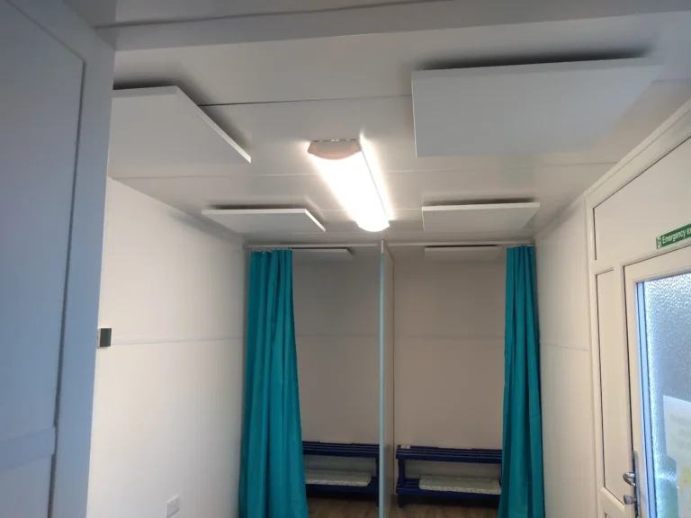 Bright room with two blue curtains, benches, and a ceiling light.